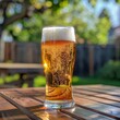 © ChomchoeiFoto - A frosty pilsner beer in a glass light and refreshing casual backyard barbecue in summer