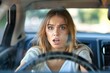 © Pinklife - A young blonde woman showing an anxious expression while driving a car