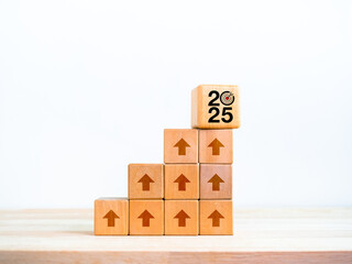 Wall Mural - 2025 year number with target icon on big wood cube on many blocks as growth graph steps with rise up arrow sign on white background. New trends, business goal, financial economic improvement concept.