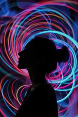 Wall Mural - A woman stands in front of a vibrant light installation, perfect for use in articles about art, culture, or technology