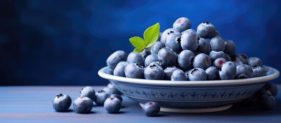 Wall Mural - closeup view of Blueberries in a plate on the table. Creative banner. Copyspace image