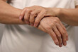 © VISUALPOINT - Close up of hands holding hands. Wrist pain concept.