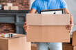 © InsideCreativeHouse - Cropped image of man carrying boxes full of stuff moving in new house. Young guy with box indoors. Moving into new home. Relocate, rental, rent, delivery, relocation and unpacking concept