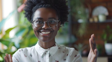 A smiling woman wearing glasses makes a peace sign, suitable for various themes including positivity, education, and human rights