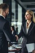 © vefimov - A professional business meeting with two people shaking hands in an office setting
