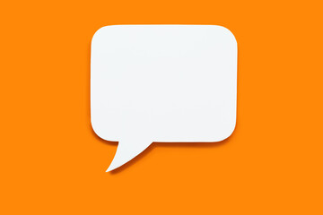 paper speech bubble in the shape of a rectangle on a orange background. flat white chat icon in the 