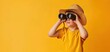 © Яна Деменишина - Childhood adventure: young explorer with binoculars on a bright orange background