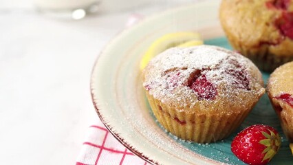 Wall Mural - Sprinkling powdered sugar on vegan strawberry muffins. Close-up. Sweet breakfast food.