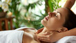 © Frank Gärtner - Woman indulges in a soothing massage at a tranquil spa featuring aromatherapy and tropical ambiance