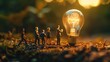 © Khalida - A group of tiny people is depicted walking towards a light bulb symbolizing the pursuit of ideas innovation and enlightenment