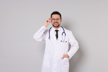 Canvas Print - Portrait of smiling doctor on light grey background