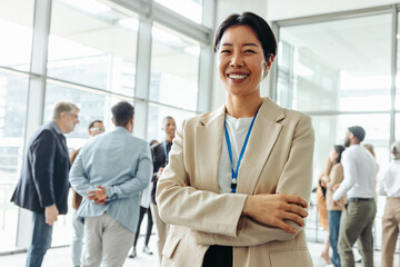 Wall Mural - confident businesswoman at an office event networking with fellow professionals