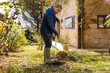 © ADDICTIVE STOCK - Man tending to garden during springtime cleanup