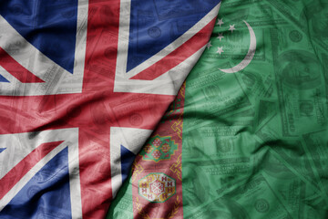 big waving colorful flag of turkmenistan and national flag of great britain on the dollar money background. finance concept.