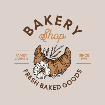 Bakery logo in vintage vector style with illustration of croissant with flowers