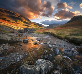 Lake District in England, showcasing its rugged landscape with rocky stream bed and colorful hills under dramatic sky. The scene captures the beauty of nature's perfect blend of earthy tones