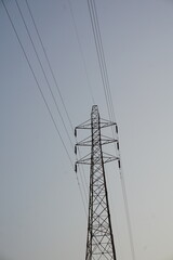 High voltage electricity transmission tower with the copy space, Electricity distribution pylon under the sky, Electricity transmission tower with blue sky background