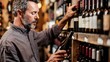 © Artyom - Middle-aged man selecting wine bottle from shelves in store