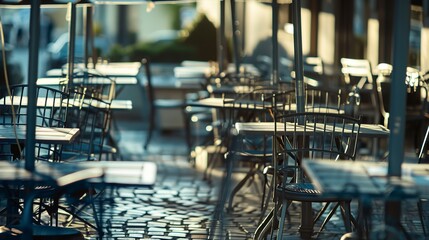 Wall Mural - Close-up of an empty bistro terrace, tables with umbrellas, no humans, quiet morning light, ready for guests 