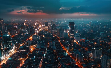 Sticker - Aerial view of the cityscape at night with illuminated buildings and streets