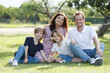 © DG PhotoStock - Caucasian family parent and their children picnic at the park in morning.