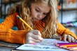 © Boomanoid - A young girl colors a coloring book at school with colored pencils