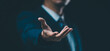 © waragron - A male hand in a suit shows a palm-up gesture against a gray background, symbolizing concepts of request, bankruptcy, and close-up.