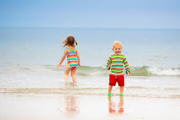 Wall Mural - Kids playing on beach. Children play at sea.