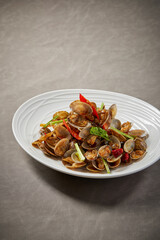 Wall Mural - traditional chinese wok fried seafood fresh clam Lala with spicy chilli sauce in plate on grey stone table asian cafe hotel luxury halal food restaurant banquet menu