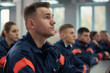 © Victor Bertrand - A group of focused young cadets in uniform attending a training session inside a formal classroom.