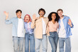 © Prostock-studio - A group of five young adults, representing diverse ethnicities and genders, stand together against a white background. They are all smiling and appear to be happy and friendly.