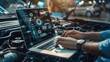 © inthasone - close-up of hands car mechanic using a laptop checking up on car engine parts for fixing and repair, automotive industry, Smart service diagnostics software concept.