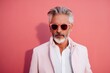 © CogniLens - Portrait of a glad man in his 50s wearing a trendy sunglasses in solid pastel color wall