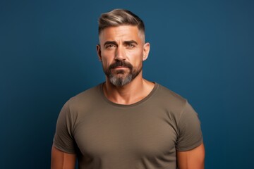 Wall Mural - Portrait of a content man in his 30s donning a trendy cropped top in front of blank studio backdrop