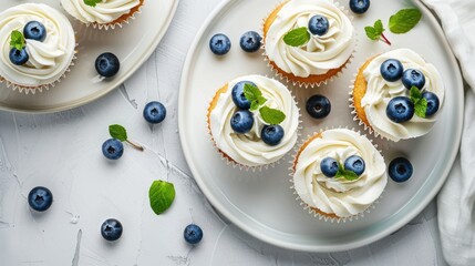 Wall Mural - Homemade blueberry and vanilla cream cupcakes on white plate Flat lay with room for text