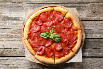 Wall Mural - Tasty pepperoni pizza on wooden table, top view
