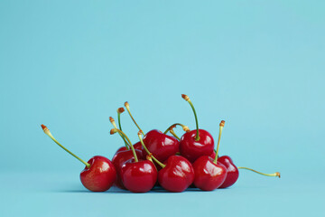 Wall Mural - a piece of cherry isolated on a light blue background