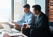 © Reese Coop/peopleimages.com - Office, teamwork and businessmen with paperwork for reading, case planning and brainstorming. Corporate firm, lawyers or attorney with document as contract policy, rules and laptop for collaboration