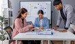 © David - Group of casually dressed asian businesspeople discussing ideas in the office. Creative professionals gathered at the meeting table for discuss important issues of the new successful startup project