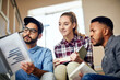 © Hira/peopleimages.com - Students, group and books on stairs for reading, learning or thinking for development at university. People, friends and scholarship for education, research or ready for assessment on steps at campus