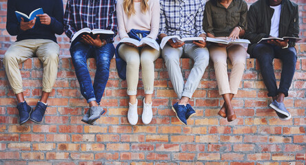Leinwandbilder - University student, friends and books on wall with legs, learning and progress for development at campus. People, group and scholarship for education, information and knowledge for future at college