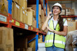 © offsuperphoto - factory worker talking on smartphone to customer in warehouse factory