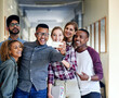 © peopleimages.com - People, group and students with selfie at college for memory, diversity or post on social media. Men, women and happy for photography with profile picture together in hallway, learning and education