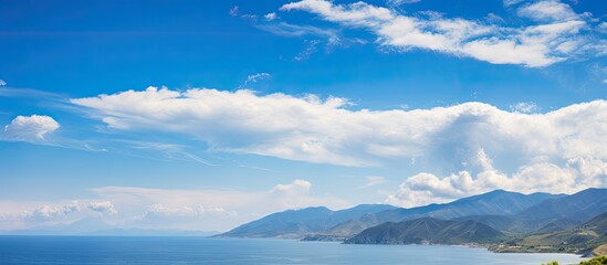 Wall Mural - coast mountains and clouds under blue sky. creative banner. copyspace image