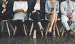 © peopleimages.com - Business, employees and office wall with legs, job interview and recruitment line up for people career in company. Waiting room, queue and candidate process for opportunity, hiring and shoes in row