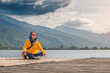 © EdNurg - A happy young woman enjoying the stunning view of Lake Plav in Montenegro during summer adventure