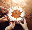 © peopleimages.com - Slice, hands and pumpkin pie on wooden table, party and Thanksgiving with celebration, event and dessert. Closeup, catering and people with food, snack and family with above, home and sweet meal