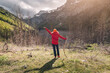 © EdNurg - A woman hiking in the mountains, using an alpenstock to explore nature and reach the peak, experiencing the freedom and adventure of outdoor leisure.