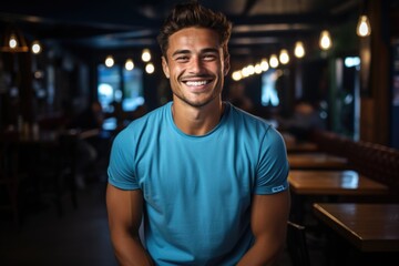 Beautiful young man wearing a casual t -shirt on his happy blue face smiling with , generative IA