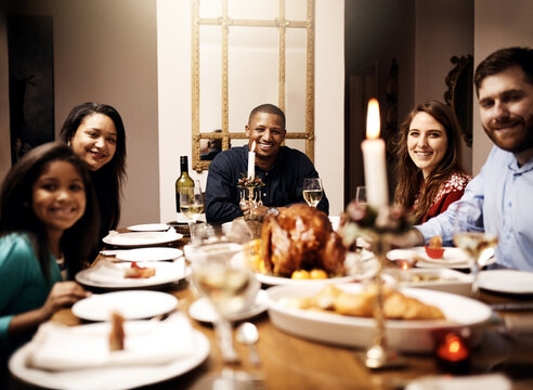 People, family and portrait on dinner table in home with smile for reunion or thanksgiving. Family, feast and happy with food for gathering or event with love, support and unity in dining table